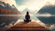 Calm morning mist meditation scene of a young woman is meditating while sitting on wooden pier outdoors with beautiful lake and mountains nature. wellness soul concept