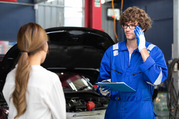 Wall Mural - mechanic talking about how to fix a car to customer in automobile repair shop