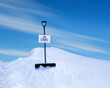 On strike sign on a shovel in a big snow bank. 