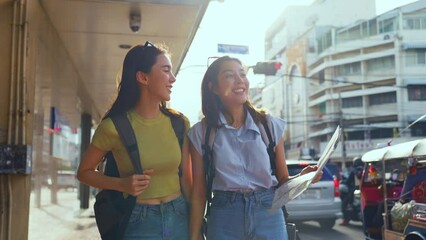 Wall Mural - Asian beautiful women backpacker friend traveling outdoor in the city. 