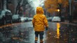 Rainy day discovery as a youngster explores wet streets in bright yellow
