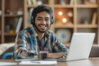 Cheerful young man with headphones using a laptop, representing the ease of learning and entertainment in the digital age