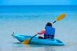kayak in the blue sea .Woman kayaking She does water sports activities 