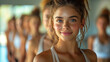 © Sudarshana - A wide photo of cute dancing girl face with slim body wearing pink color top, practicing aerobics with the team colorful dresses in a background in a gym