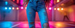 © Sudarshana - A wide photo, a hip of cute girl with slim body wearing blue color jeans in a background with neon color ambience night club background