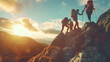 Group of hikers on a mountain and woman helping her friend to climb a rock