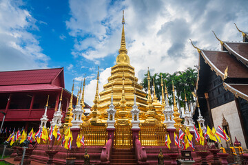 Wall Mural - Beautiful Ancient golden color Pagoda in the Phan Tao temple  is a Buddhist temple in the historic centre tourist attraction an ancient Thai art and is Public places in Chiang Mai,Thailand.