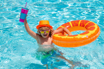 Kid boy relaxing in pool. Summer kids cocktail. Child swimming in water pool. Summer kids activity, watersports. Summer vacation with children. Child enjoying summer in the water in the swimmingpool.