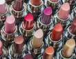 Top view of lipsticks in various color. Cosmetic texture made with make up accessories
