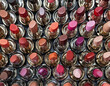 Top view of lipsticks in various color. Cosmetic texture made with make up accessories