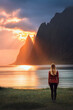 Woman walking on Ersfjord beach in Norway travel solo harmony with nature healthy lifestyle traveler exploring Senja island girl tourist enjoying sunset landscape sea and rocks summer vacation outdoor