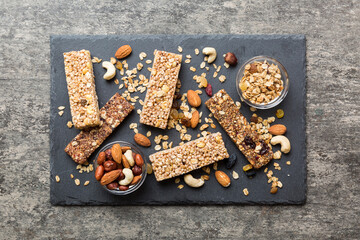 Canvas Print - Various granola bars on table background. Cereal granola bars. Superfood breakfast bars with oats, nuts and berries, close up. Superfood concept