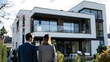 © Gita - investment decision,  people are looking at a new modern house