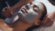 A woman receiving a facial treatment at a spa. Perfect for beauty and skincare concepts