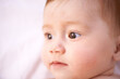 © Tasneem/peopleimages.com - Closeup, girl and baby on bed with curiosity for childhood development, growth and relax in nursery. Newborn, ginger and kid with wonder for wellness, knowledge and calm child in bedroom from above