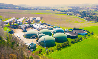 Wall Mural - Biogas plant and farm in fields. Renewable energy from biomass. Agriculture prepared for Green Deal. Aerial view to Czech industry. Sustainable development in European Union. 