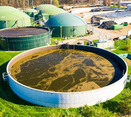 Wall Mural - Biogas plant and farm in fields. Renewable energy from biomass. Agriculture prepared for Green Deal. Aerial view to Czech industry. Sustainable development in European Union. 