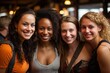 Portrait of a group of four girls of different nationalities, a meeting of friends in a cafe.