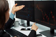 © Summit Art Creations - Two business traders discussing on dynamic stock market in currency rate investment trading on two pc screens with compare real time graph on risk or profit point of data at modern office. Postulate.