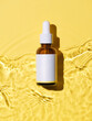 minimalistic image featuring a brown glass dropper bottle with a blank white label against a textured yellow backdrop.