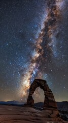 Wall Mural - Milky way arching over a natural rock formation