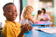 © Monkey Business - Portrait Of Male Primary Or Elementary School Student At Desk In Multi-Cultural Class