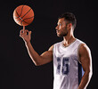 © Duncan/peopleimages.com - Man, basketball playing and finger or sports game in studio or professional exercise, athlete or black background. Male person, training and fitness spinning or workout competition, uniform or mockup