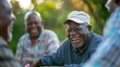 © Studio Nova - Senior men with smiles engage in a card game outdoors.