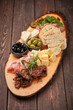 gourmet charcuterie board on rustic wooden table
