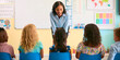 © Monkey Business - Rear View Of Primary Or Elementary School Students Sitting In A Line In Chairs Listening To Teacher