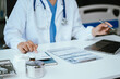 © NINENII - Doctor use a service fee calculator to save money on health insurance, drug cost concept.