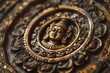 Detailed view of a golden Buddha statue, showcasing intricate religious symbols and cultural significance