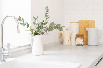 Gray kitchen counter top with white stone sink and decoration utensils