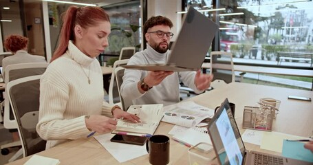 Poster - Focused business colleagues are collaborating on a new project and brainstorming solutions in a modern office environment, showcasing their teamwork and innovative thinking.