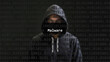 Cyber attack malware text in foreground screen, anonymous hacker hidden with hoodie in the blurred background. Vulnerability text in binary system code on editor program.