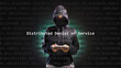 Cyber attack distributed denial of service text in foreground screen, anonymous hacker hidden with hoodie in the blurred background. Vulnerability text in binary system code on editor program.