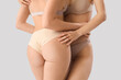 © Pixel-Shot - Beautiful young women in stylish beige underwear on grey background