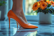 Shining female feet elegantly wearing bright and carefully tailored high heels. The concept of shoes that create beauty.
