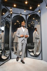 Wall Mural - Young african man shopping in clothing store