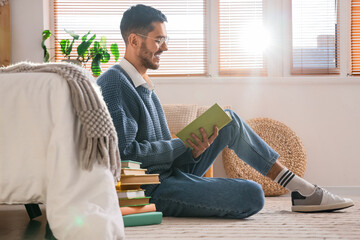 Canvas Print - Young man reading book in bedroom