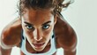 © Christian Bunge - attractive and confident female athlete ready for running, picture taken from the ground, eye contact to the camera, white background, 16:9