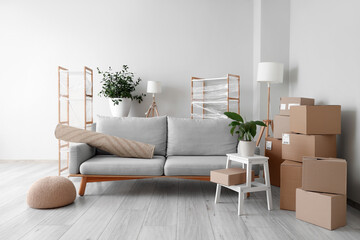 Canvas Print - Cardboard boxes and sofa prepared for house moving in living room