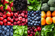 Collage of different fruits and vegetables including raspberries blueberries oranges and spinach.