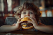 © Xchip - little caucasian boy eating burger, looking camera