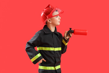 Sticker - Cute little firefighter with toy extinguisher on red background