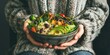 poke with vegetables, avocado, beans and broccoli in bowl in women's hands, healthy vegetable salad