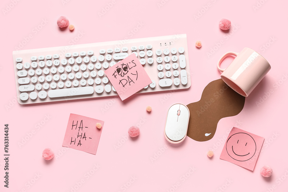 Computer keyboard, sticky notes and prank with spilled cup of coffee on pink background. April Fools Day prank