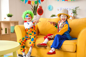 Poster - Funny little children in clown costumes at home. April Fools' Day celebration