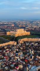 Wall Mural - Vertical aerial drone view of Palace of the Parliament in Bucharest downtown at sunset. Romania