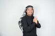 © Aria Armoko - Happy smiling Asian Muslim man in Arabic turban sorban standing with Eid greeting gesture and welcoming Ramadan isolated